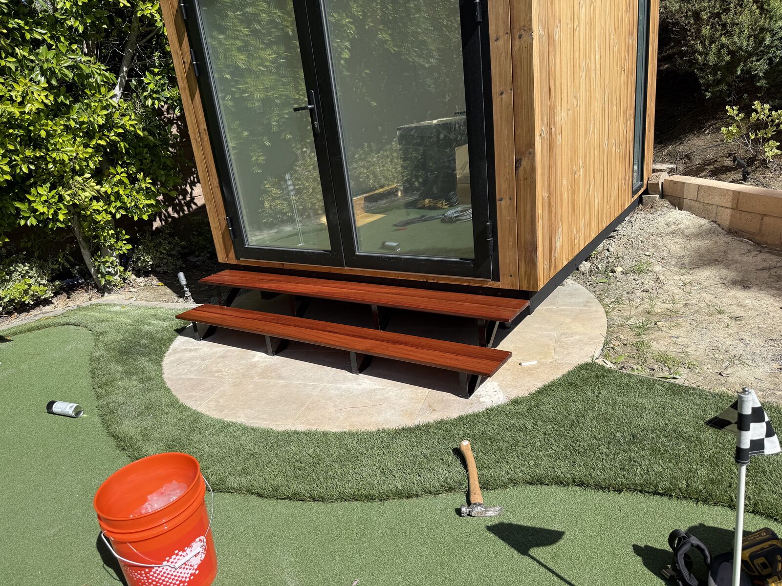 Wood-clad backyard studio with glass doors