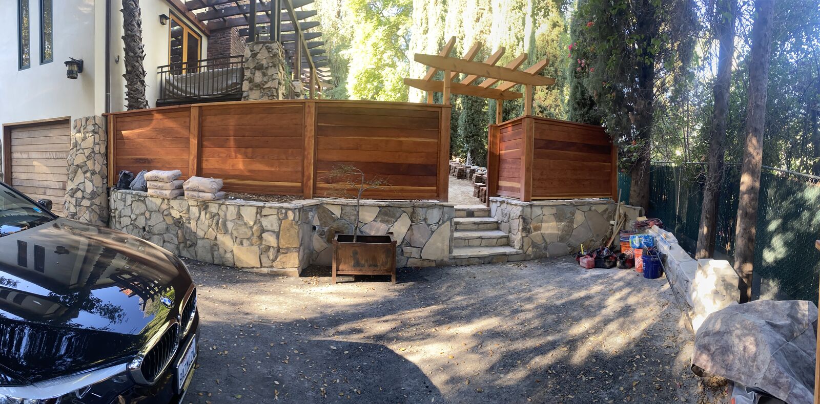 Custom stone retaining wall with wood gates